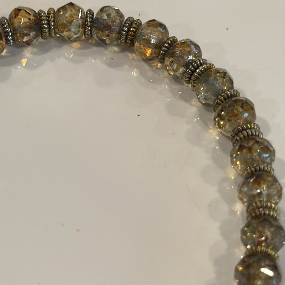 Handcrafted artisan crystal bracelet with gold lotus flower charm.